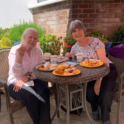 Two residents enjoying lunch outside