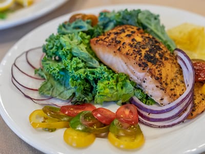 A plate of grilled salmon with vegetables