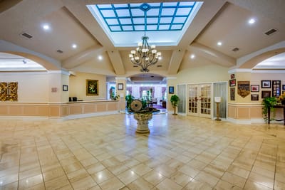 Interior view of a spacious lobby area with chandelier