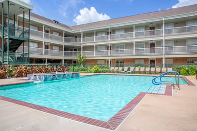 Swimming pool area with accessible entry and landscaping