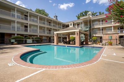 A serene pool area surrounded by residential buildings