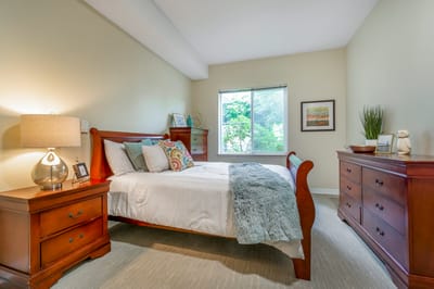 A cozy bedroom with wooden furniture and natural light