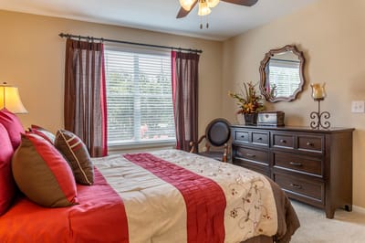 Cozy interior of a resident room with bed and furniture