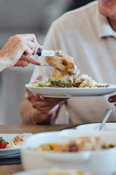 Close-up of residents enjoying a meal together