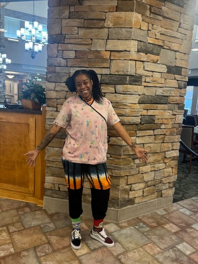 Staff member posing in a common area