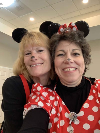 Two staff members in festive costumes