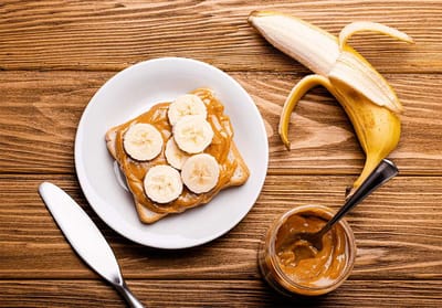 Toast with peanut butter and banana slices on a plate
