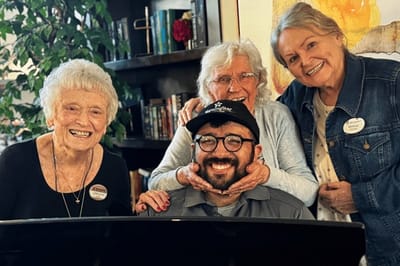 Residents enjoying time with staff in a common area