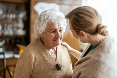 A warm interaction between an elderly woman and a caregiver