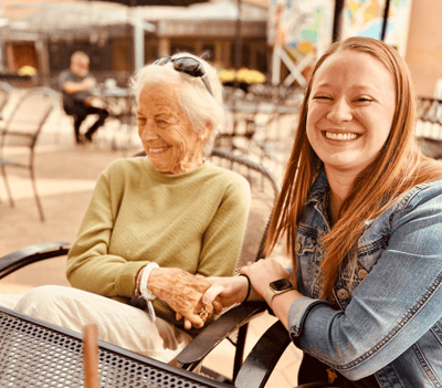A resident and caregiver enjoying time together outdoors