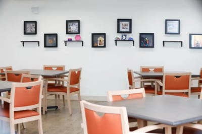 Interior view of a dining area with frames on the wall