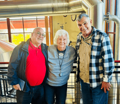 Three residents posing together in a common area