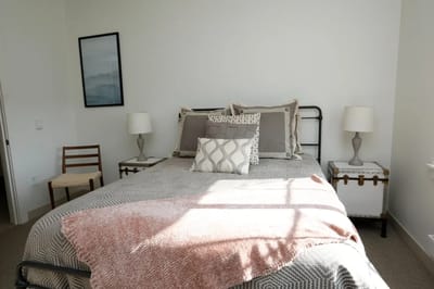 Cozy bedroom with a neatly made bed and decor