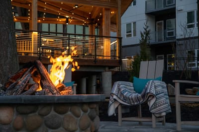 Outdoor fire pit with seating near the facility exterior