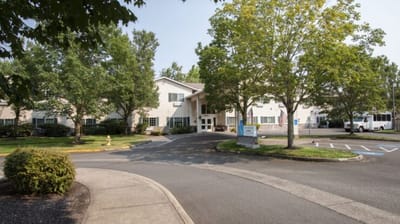 Exterior view of Cadence at Olney with trees and driveway