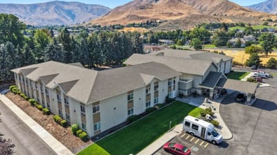 Aerial view of the assisted living facility with outdoor space and a shuttle van