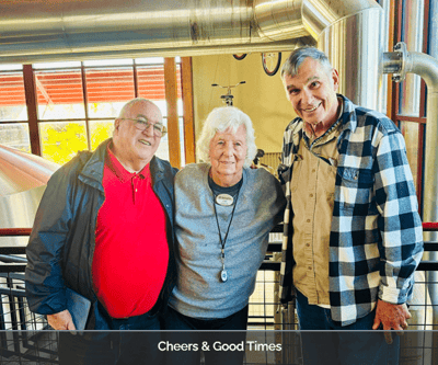 Three residents posing together in a common area
