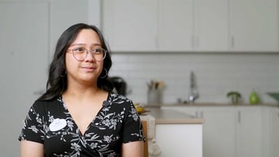 A staff member in a bright kitchen area