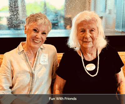 Two residents smiling together in a common area