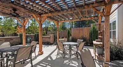 Outdoor patio area with tables and shade