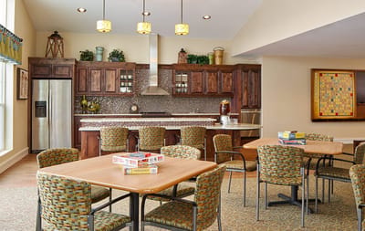 Bright common area with dining tables and kitchen