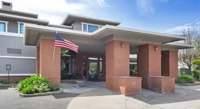 Front entrance of a senior living facility with landscaping