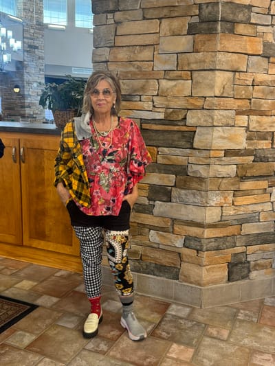 Resident posing in a brightly decorated interior