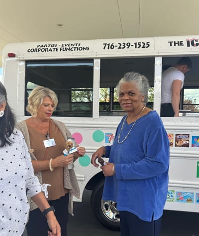 Residents enjoying ice cream near a service vehicle