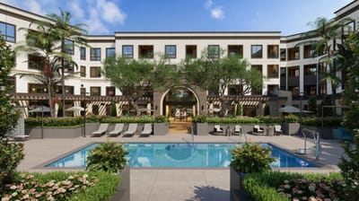 Outdoor pool area with seating and greenery