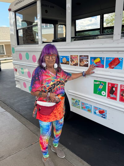 A resident in colorful clothing at an ice cream cart