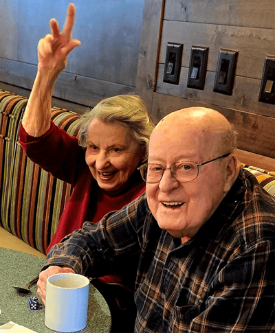 Two residents enjoying coffee in a common area
