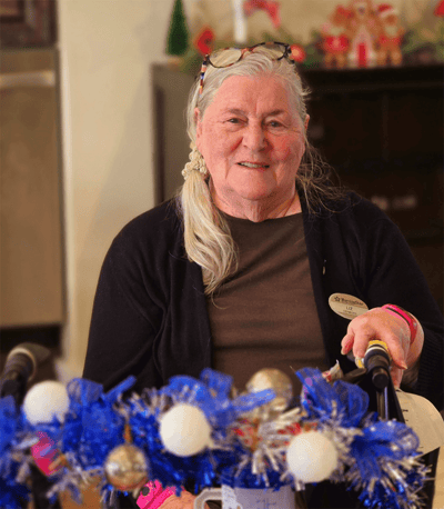 Resident smiling in a common area decorated for a celebration