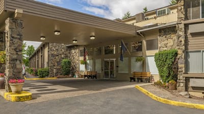 Entrance view of a senior living facility with stone architecture