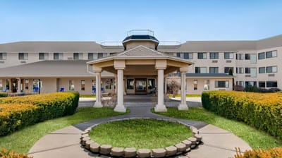 Exterior view of the facility with landscaped gardens