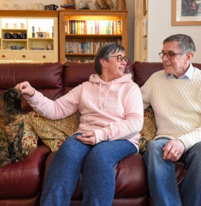 Residents enjoying time together with a cat in a cozy living area