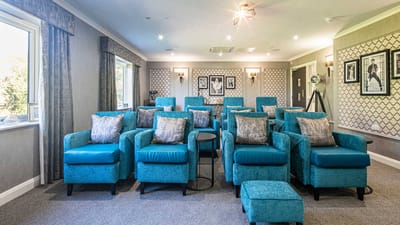 Bright interior of a common area with teal chairs
