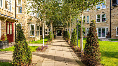 Pathway through landscaped garden with trees