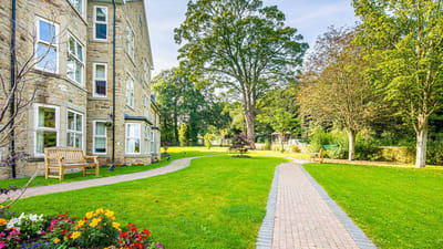 Well-maintained gardens and pathways outside the facility