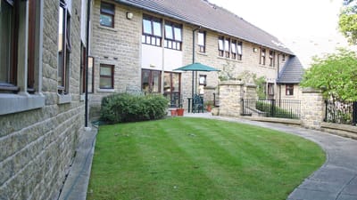 Well-maintained outdoor space with grass and patio