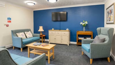 Comfortable living room area with blue accent wall