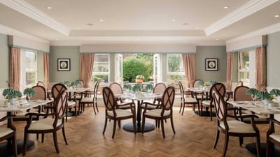 Bright dining room with tables set for meals