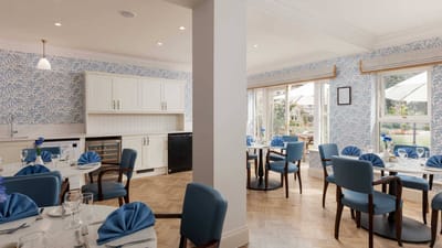 Bright dining room with tables set for meals
