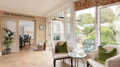 Bright tea room with seating and garden view