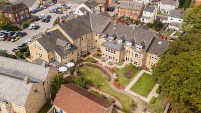 Aerial view of a senior living facility with gardens