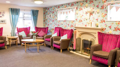 Bright common area with floral wallpaper and comfortable seating