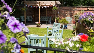 Outdoor garden area with seating and flowers