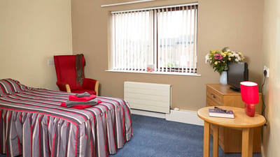 Cozy resident room with a bed and flowers