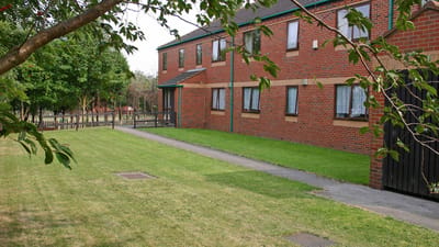 Exterior view of a care facility with green space