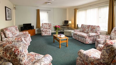 Comfortable common area with floral-patterned seating