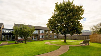 Outdoor area with well-maintained gardens and pathway